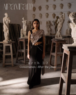 Model Natascha Mehra wearing a modern black saree with metallic blouse, standing in an art studio filled with classical sculptures for Jadon’s Arth 3.0 campaign 