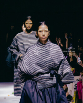 Dipannita Bhuyan walking the runway for Raw Mango in a patterned oversized jacket and skirt at a fashion show 