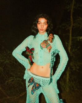 Model Akriti Jha wearing a turquoise crochet outfit with colorful bows for Contributor Magazine editorial shoot 