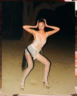 Model Akriti Jha posing in a sheer embellished corset dress with metallic platform heels during a dramatic night shoot for Contributor Magazine 