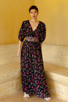 Merrylin Boro in a flowy black floral maxi dress with a sequin-embellished waistband by Verandah 