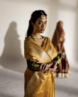 Medhavi Chettri wearing a golden silk sari with green blouse and traditional jewelry for Mimamsaa 