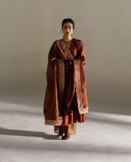 Medhavi Chettri in a rust-colored traditional outfit with embroidered dupatta, styled with a maang tikka, for Mimamsaa 