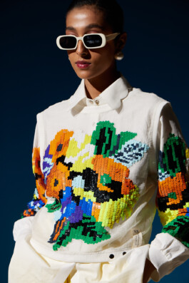 Model Akriti Jha wearing a white shirt with bold multicolored sequin floral embroidery for Mohammed Mazhar campaign 