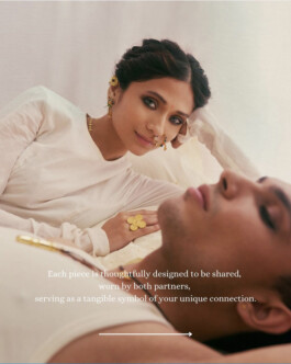 Model Anushree Vaze in traditional-inspired Olio jewelry, laying beside a male model, both dressed in white 