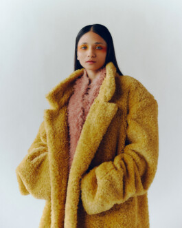 Anushree Vaze wearing a mustard yellow fur coat and pink textured top for Dirty Magazine editorial 