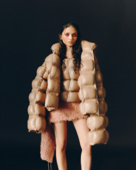 Anushree Vaze wearing a sculptural nude puffer jacket and textured mini skirt for Dirty Magazine fashion editorial 