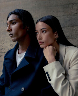 Savio Fedrick and a female model in a striking editorial portrait wearing navy and cream blazers 