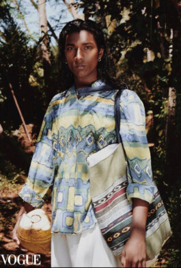 Savio Fedrick holding a coconut and wearing a printed shirt and textile bag, photographed outdoors for Vogue India 