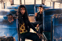 Model Savio Fedrick in eclectic fashion editorial shoot for Paise campaign inside vintage Indian bus, captured in gritty and nostalgic style 