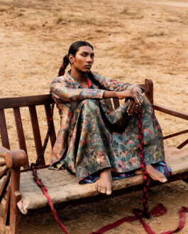 Model Savio Fedrick wearing a multicolored printed suit with long braids for Suket Dhir campaign 
