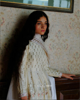 ALF Model Deepika Sagar in an ivory embroidered kurta, leaning against a vintage wallpapered wall for Bruhi Pant campaign 