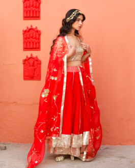 Model Deepika Sagar wearing a red and gold lehenga with floral embroidery for Aikeyah's fashion campaign 