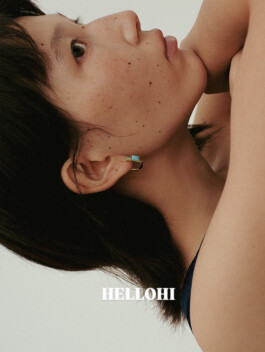 Close-up of model Ngawang Jinpa wearing gold and turquoise earring for Hellohi campaign, photographed in soft natural light 