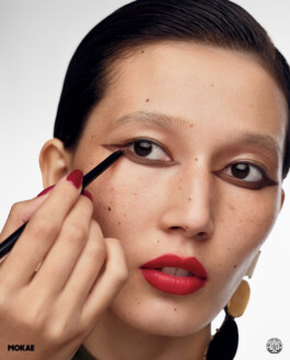 Ngawang Jinpa close-up for Mokae Beauty as a makeup artist applies dramatic brown eyeliner, with red lips and graphic styling 
