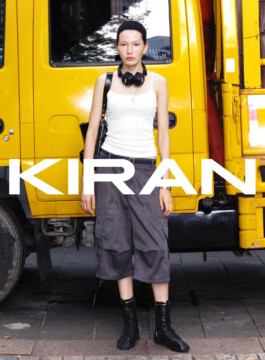 Ngawang Jinpa, ALF model, poses in front of a yellow truck for Kiran campaign in urban fashion look 