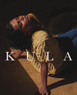 ALF model Ishra Philipose in dramatic sunlight wearing a textured yellow top and blue trousers for the Kula campaign 