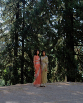 Medhavi Chettri and Deepika Sagar standing in embellished sarees amidst tall pine trees for the Bruhi Pant Bhor campaign 