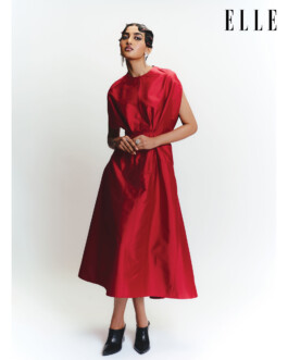 Female model in a structured red dress posing for ELLE Fresh Face feature, styled in a clean studio setting with editorial fashion styling. Represented by ALF – A Little Fly, a leading modeling agency in India. 