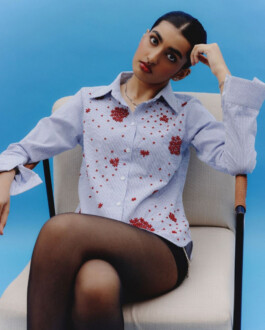 Model Yashvi Birla wears a blue pinstripe shirt with red embellishments and sheer black tights for Ose Studios, represented by ALF modeling agency in India 