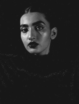 Black-and-white close-up portrait of model Yashvi Birla with bold dark lipstick and dramatic lighting. 