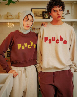 Ngawang Jinpa and male model in coordinated Psuche sweatshirts in a cozy kitchen setting 