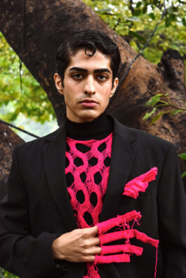 Model Siddharth Raghavan in a black blazer with pink knit details during an outdoor test shoot 