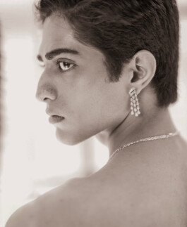 Monochrome portrait of model Siddharth Raghavan wearing statement diamond earrings and necklace in an editorial shoot 