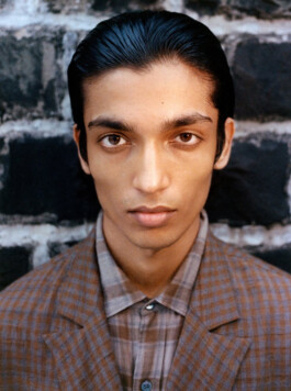 Close-up of Aaditya Yadav in checkered brown suit and slicked-back hair for Itoh fashion editorial 