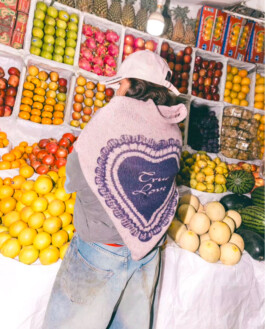 Tania Shroff wearing Acne Studios in front of a vibrant fruit stall, photographed by ALF’s Tito for Ajio campaign 