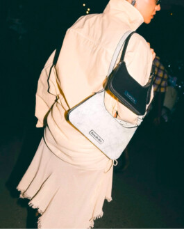 Tania Shroff in a cream outfit carrying black and white Acne Studios handbags, photographed from the back at night by ALF’s Tito for Ajio 