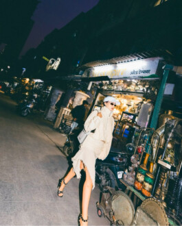 Tania Shroff walks through an antique market at night in an edgy neutral-toned outfit for Ajio x Acne Studios, photographed by Tito 