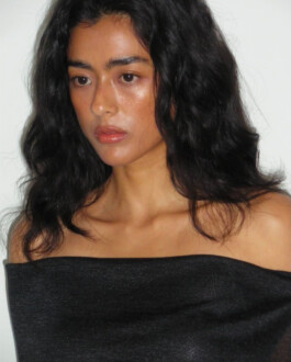 Close-up portrait of Medhavi Chettri in a black off-shoulder top with natural dewy makeup – Polysooem Lookbook 