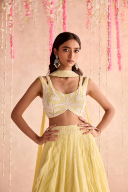 Dimple Aggarwal poses in a yellow embellished lehenga with statement earrings for Seema Thukral’s lookbook campaign 