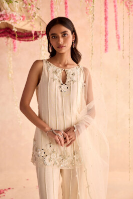 Close-up of model Dimple Aggarwal wearing an ivory embroidered kurta with floral details and sheer dupatta for Seema Thukral 
