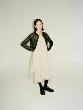 Model Ngawang Jinpa wearing a minimal beige dress with sheer black overlay for Essential by EQL fashion campaign 