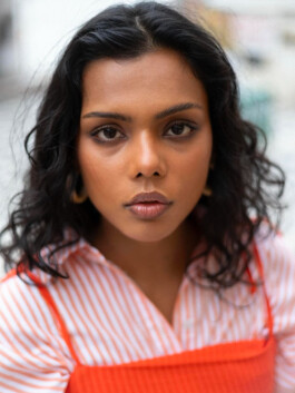 Close-up of Ishra Philipose in orange and striped outfit for Wasala campaign 