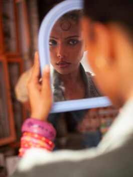 Ishra Philipose looking into mirror wearing bindi and bangles for Wasala campaign 