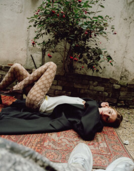 Model in Gucci tights lying on vintage rug in moody outdoor fashion editorial by ALF photographer Tuhin Chandra 
