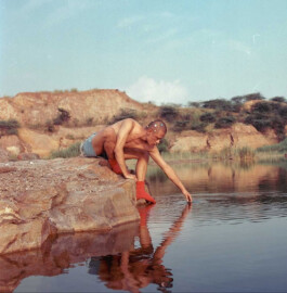 ALF model Sachit Gurung crouching by a lake with star stickers on head, captured by ALF photographer Prakrit Rai for A Little Fly, a top modeling agency in India 
