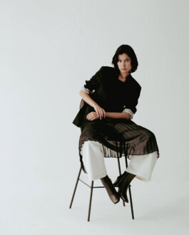 Model sitting on a stool in layered black and white outfit captured by ALF photographer Prakrit Rai for A Little Fly, one of India’s top modeling agencies 