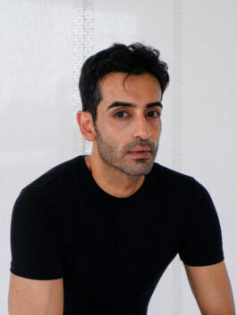 Close-up digital of Vikas Mandaliya in a black t-shirt with natural expression and minimal background 