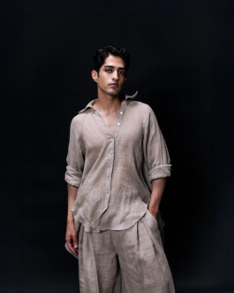 Siddharth Raghavan wearing a beige linen shirt and matching pleated pants, relaxed pose for Puri lookbook by A Little Fly modeling agency 