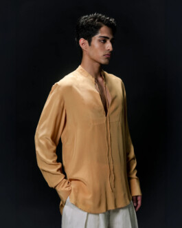Siddharth Raghavan in a mustard silk shirt and ivory linen trousers, side profile portrait for Puri lookbook by A Little Fly modeling agency 