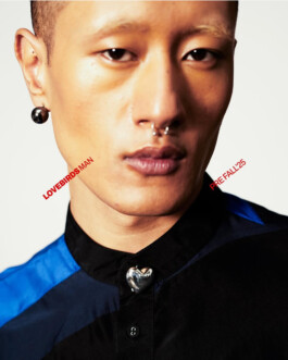 Close-up of Sachit Gurung wearing a black and blue shirt with a metallic heart detail, styled for Lovebirds Men Pre-Fall 2025 campaign by A Little Fly 
