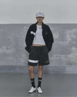 Ngawang Jinpa in Alfred SS25 lookbook wearing black shorts, cropped white top, jacket, and cap, styled with Platinum Models Seoul for A Little Fly modeling agency India 