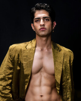 Siddharth Raghavan wearing an open gold jacket, shirtless with visible abs, posing for Puri lookbook campaign by A Little Fly modeling agency 