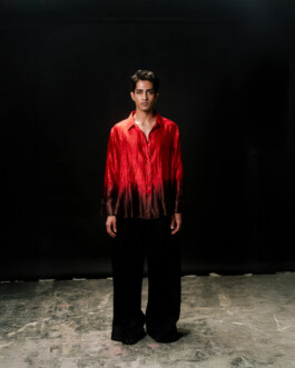 Siddharth Raghavan wearing a red ombré silk shirt and wide black trousers, full-body shot for Puri lookbook by A Little Fly modeling agency 