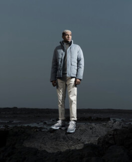 Albhei Ghazi, Indian male model represented by A Little Fly (ALF India), wearing winter fashion in an outdoor photoshoot on rocky terrain 
