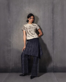 Medhavi Chettri, represented by ALF modeling agency, in a graphic t-shirt with tiger motif, layered dark trousers, and pointed heels for the Almost Gods campaign. 